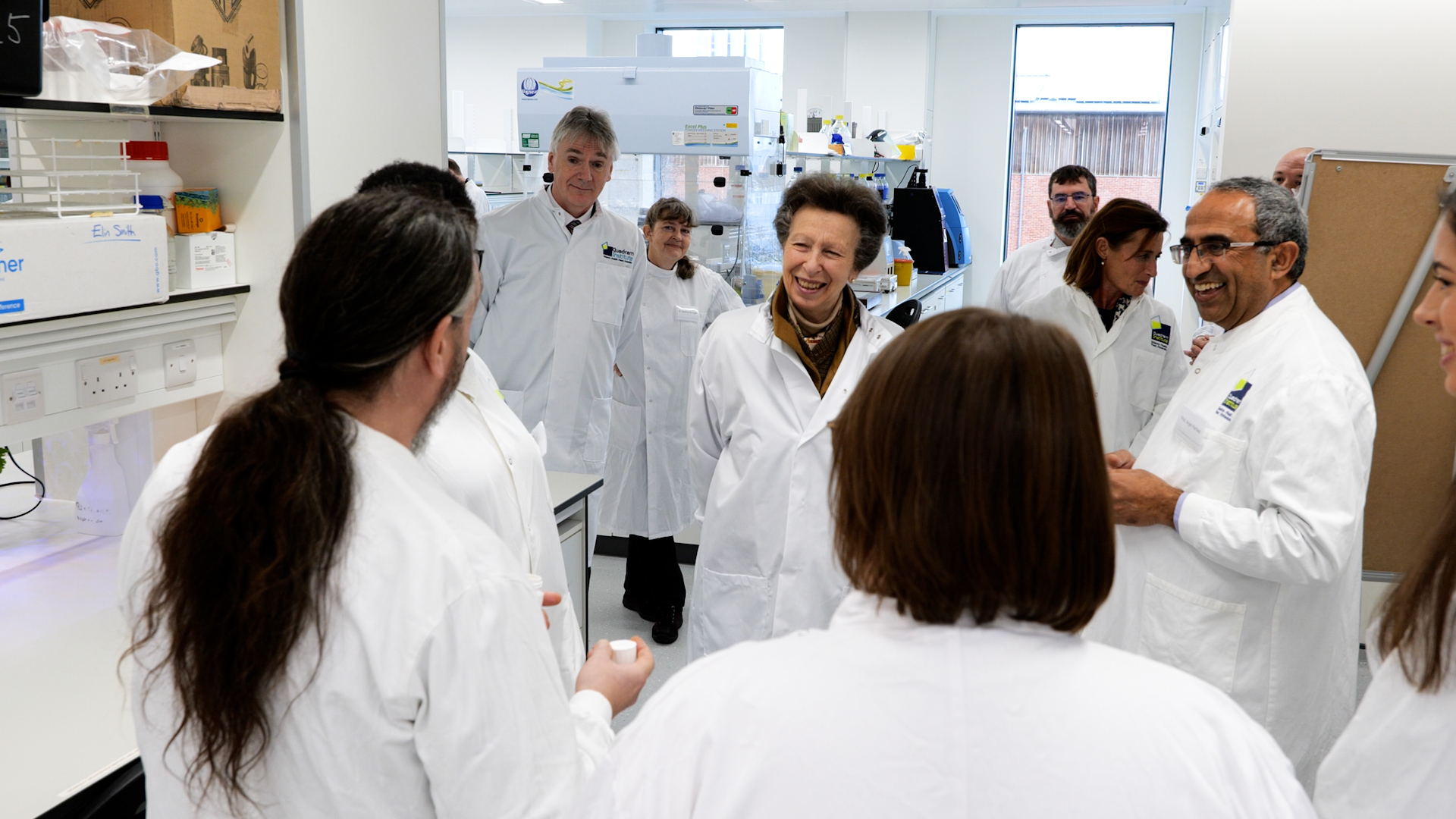 Princess Anne greeting scientists in a lab