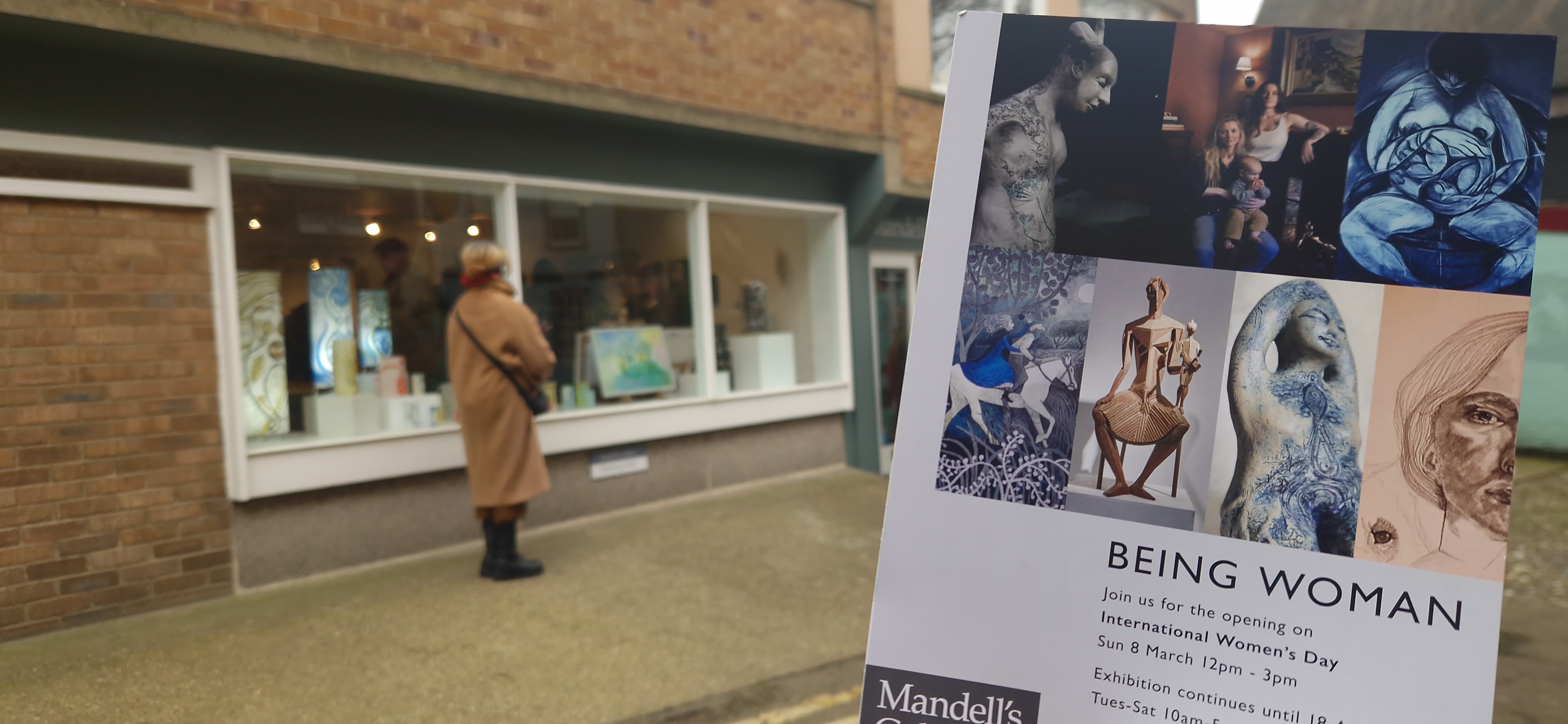 Leaflet advertising a gallery outside a small brick building.